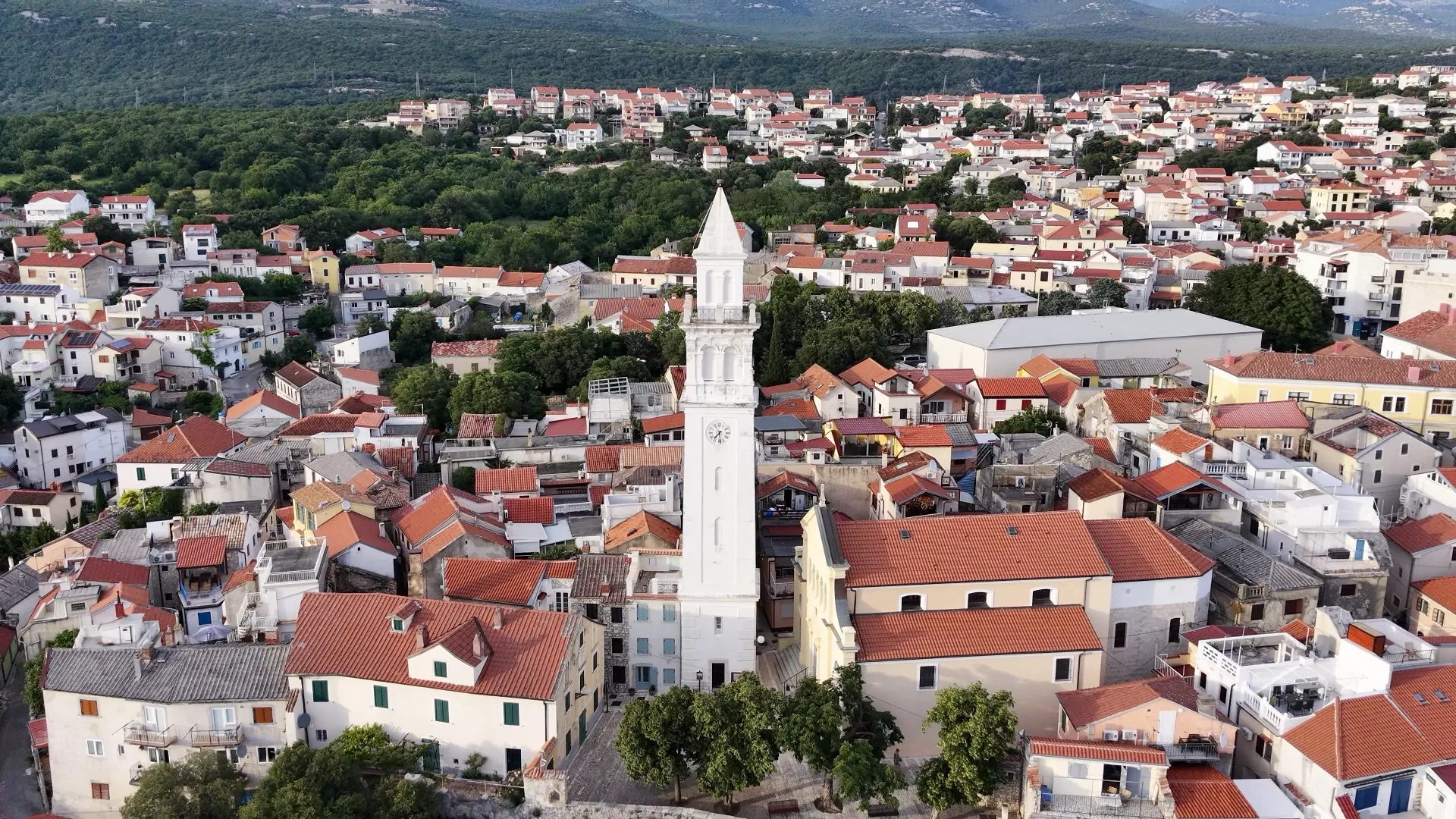 Aerial view of the church tower and red-roofed old town in Novi Vinodolski