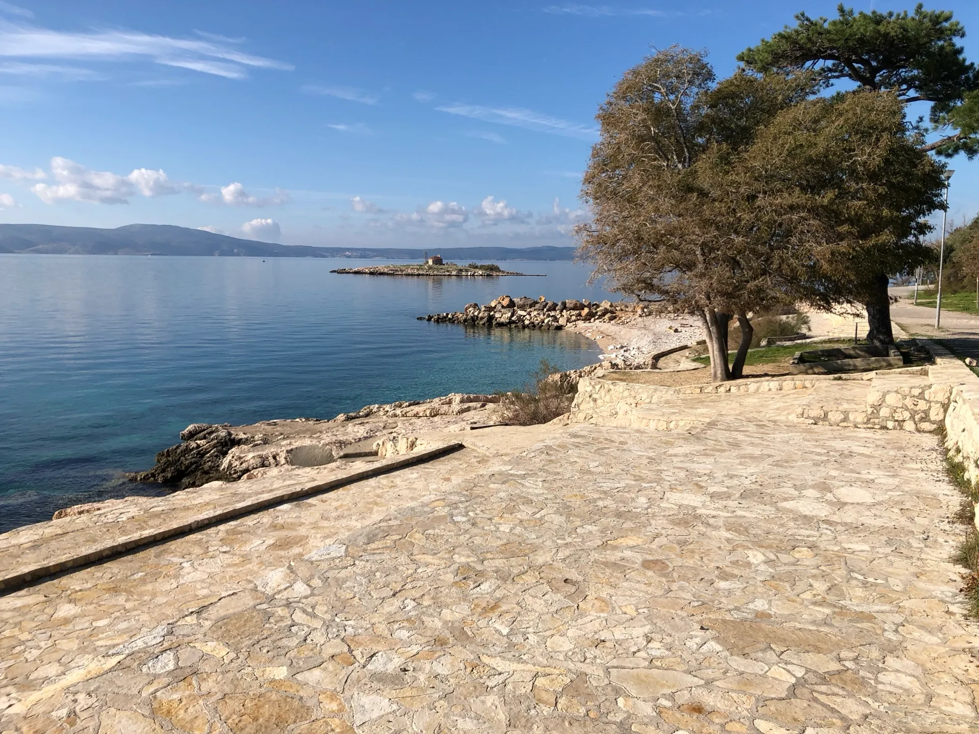Calm coastline near Lišanj Beach with San Marino Islet offshore