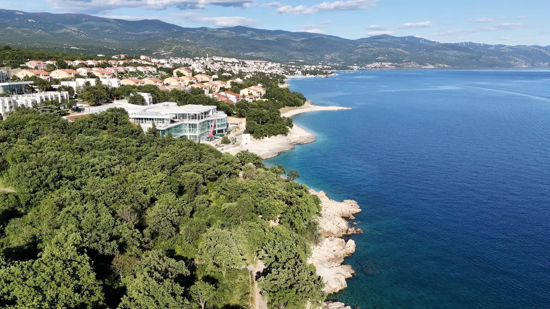 Aerial view along Obala Petra Krešimira IV, its rocky shore and nearby buildings