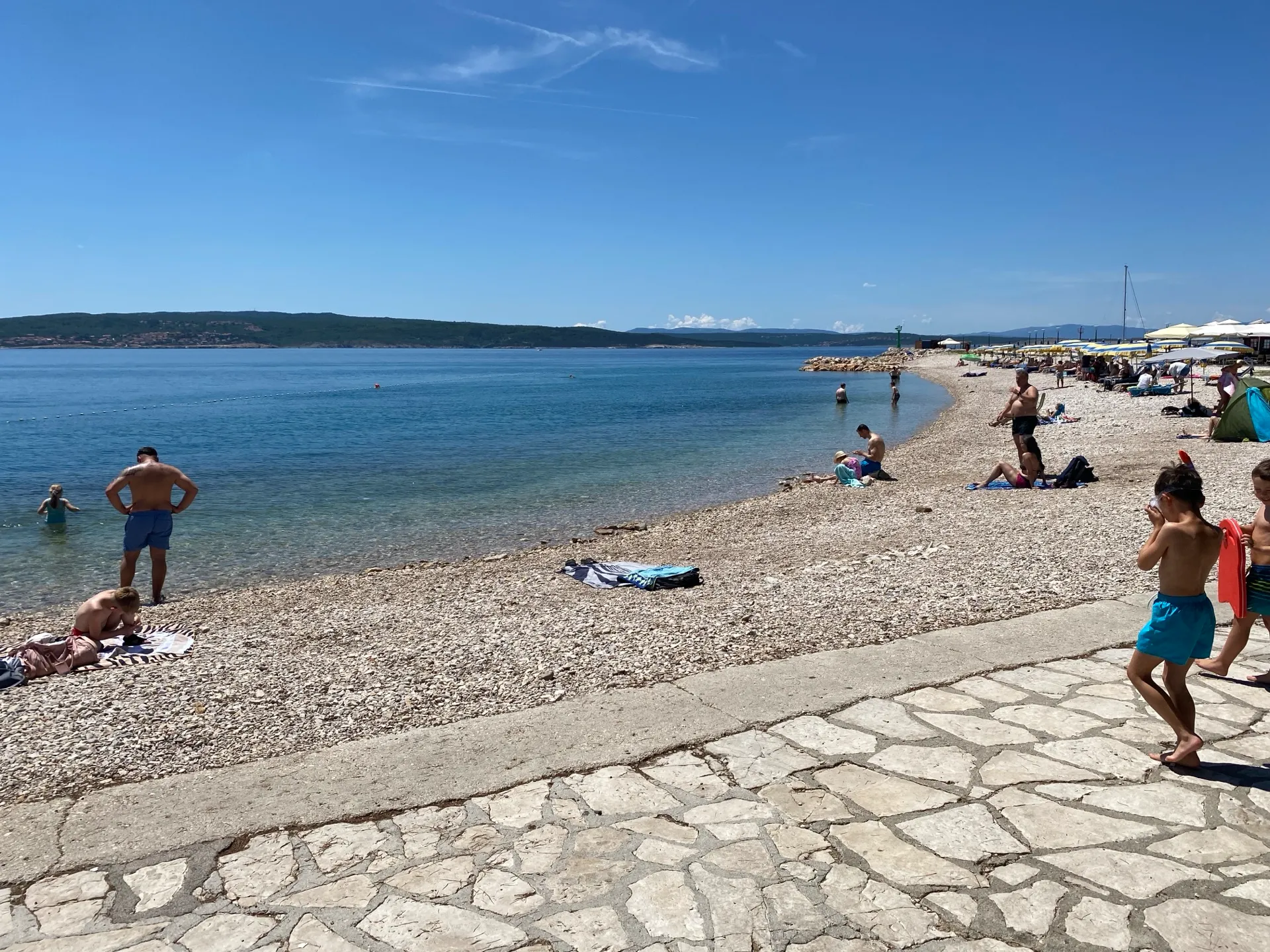 Wide pebble beach and clear sea in Crikvenica