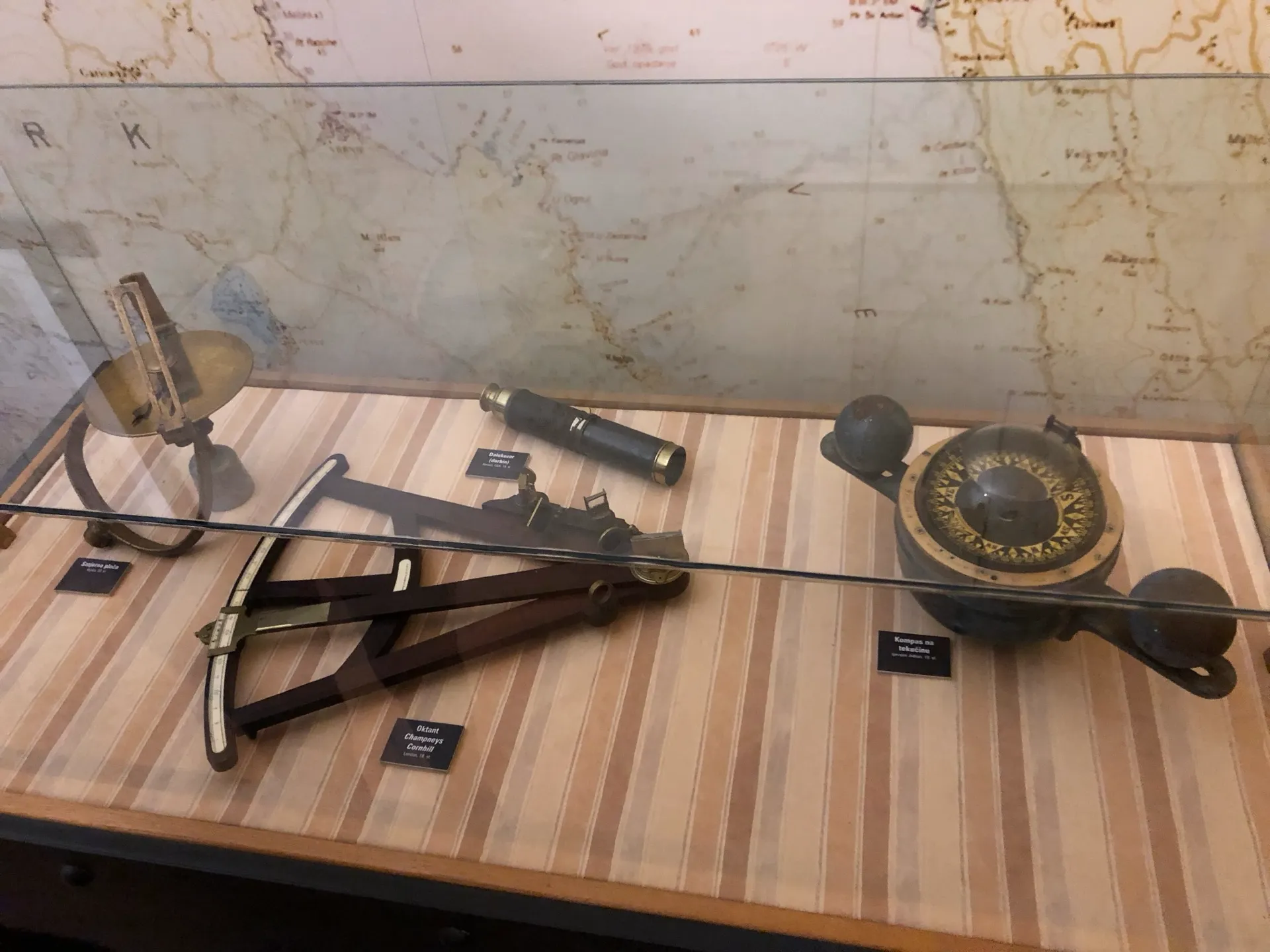 Historic navigation instruments displayed with a maritime map in Rijeka